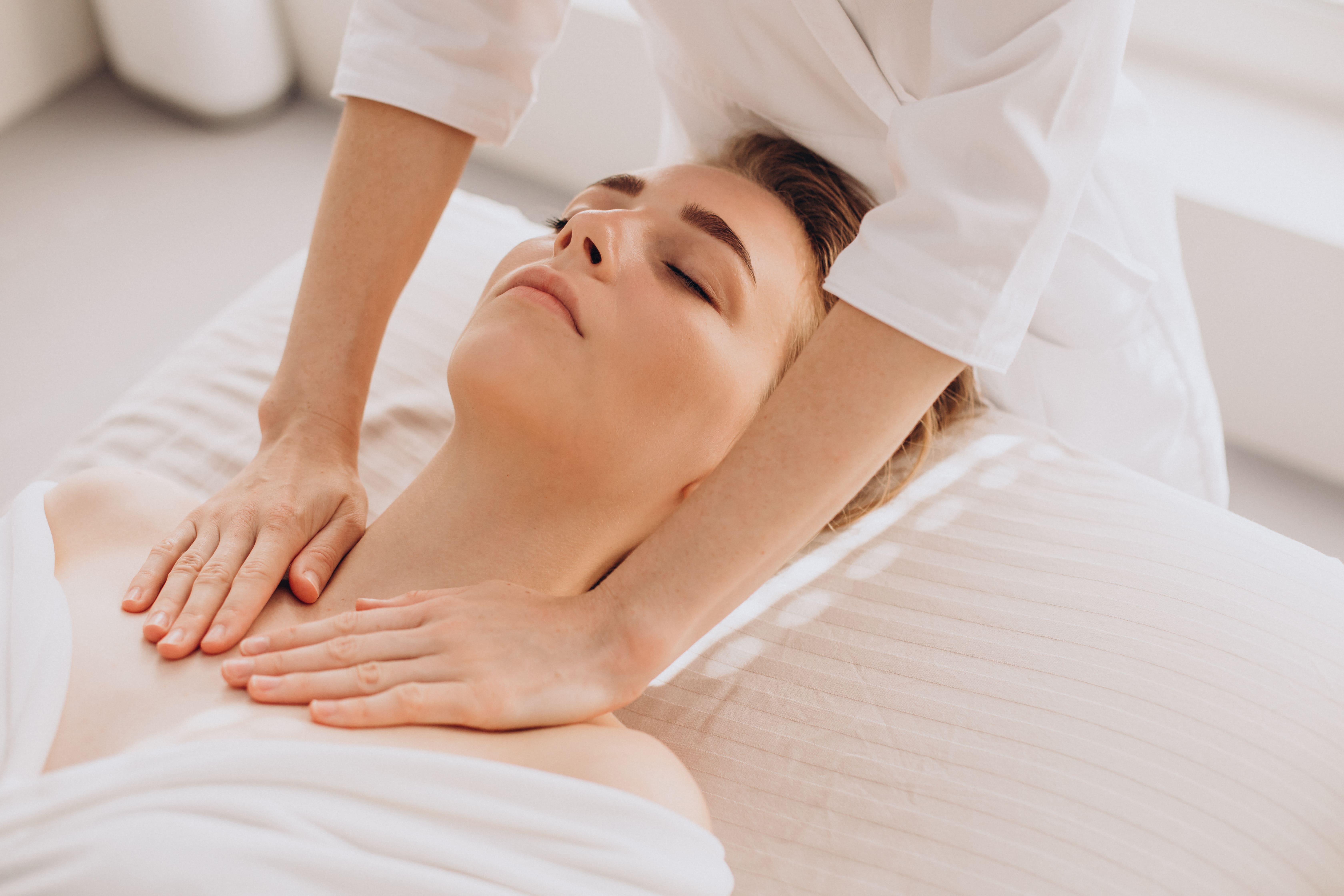 woman-beauty-salon-having-face-neck-massage-min