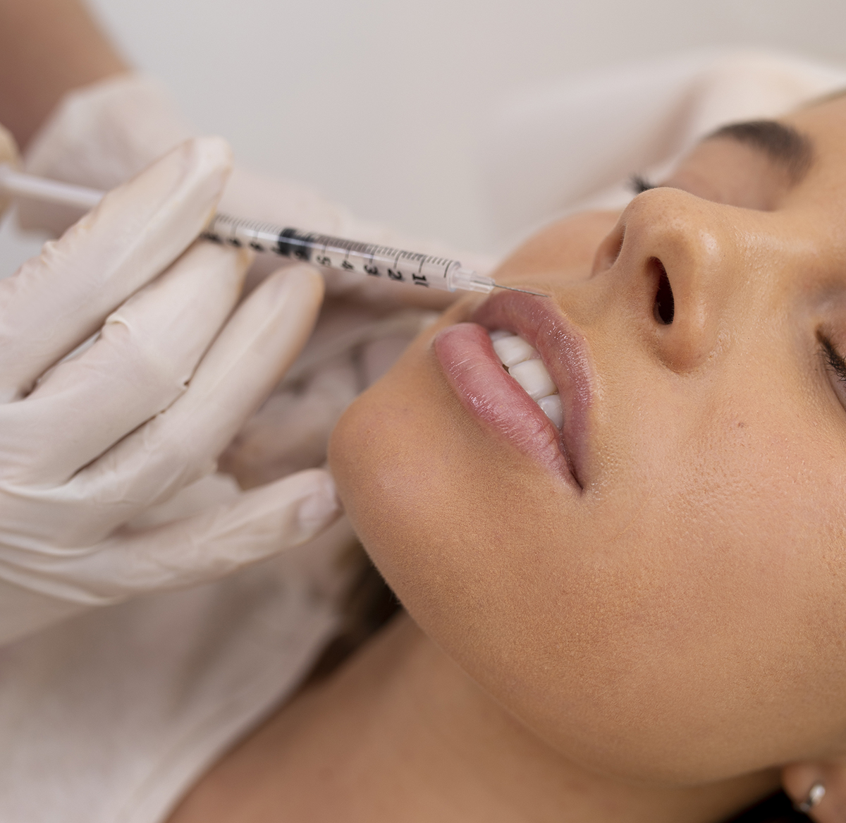 close-up-woman-getting-lip-filler-with-injection