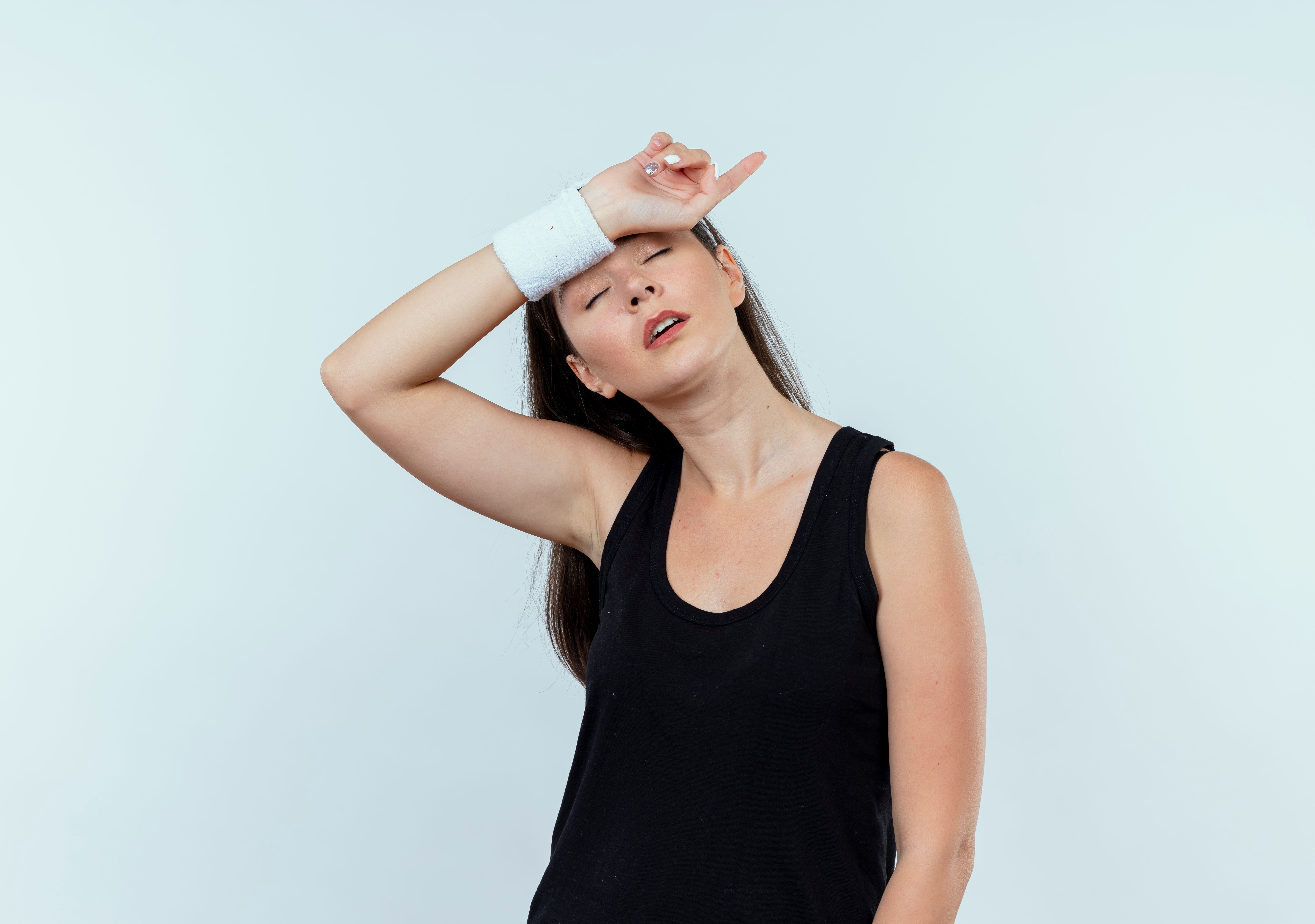 young-fitness-woman-headband-looking-tired-exhausted-after-workout-standing-white-wall (1)